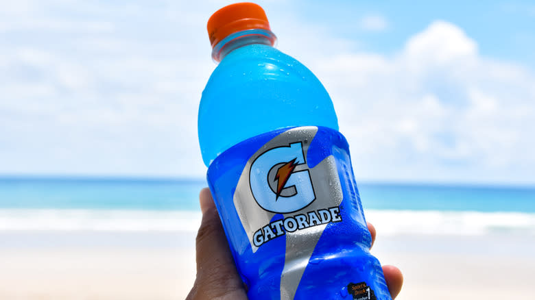 Holding bottle of blue Gatorade