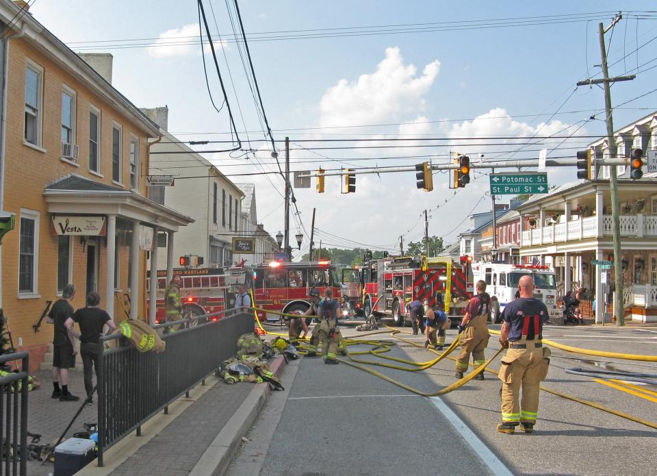 Firefighters work at the scene of an Aug. 9, 2021, fire that heavily damaged the Vesta Pizzeria & Family Restaurant on Main Street in Boonsboro.