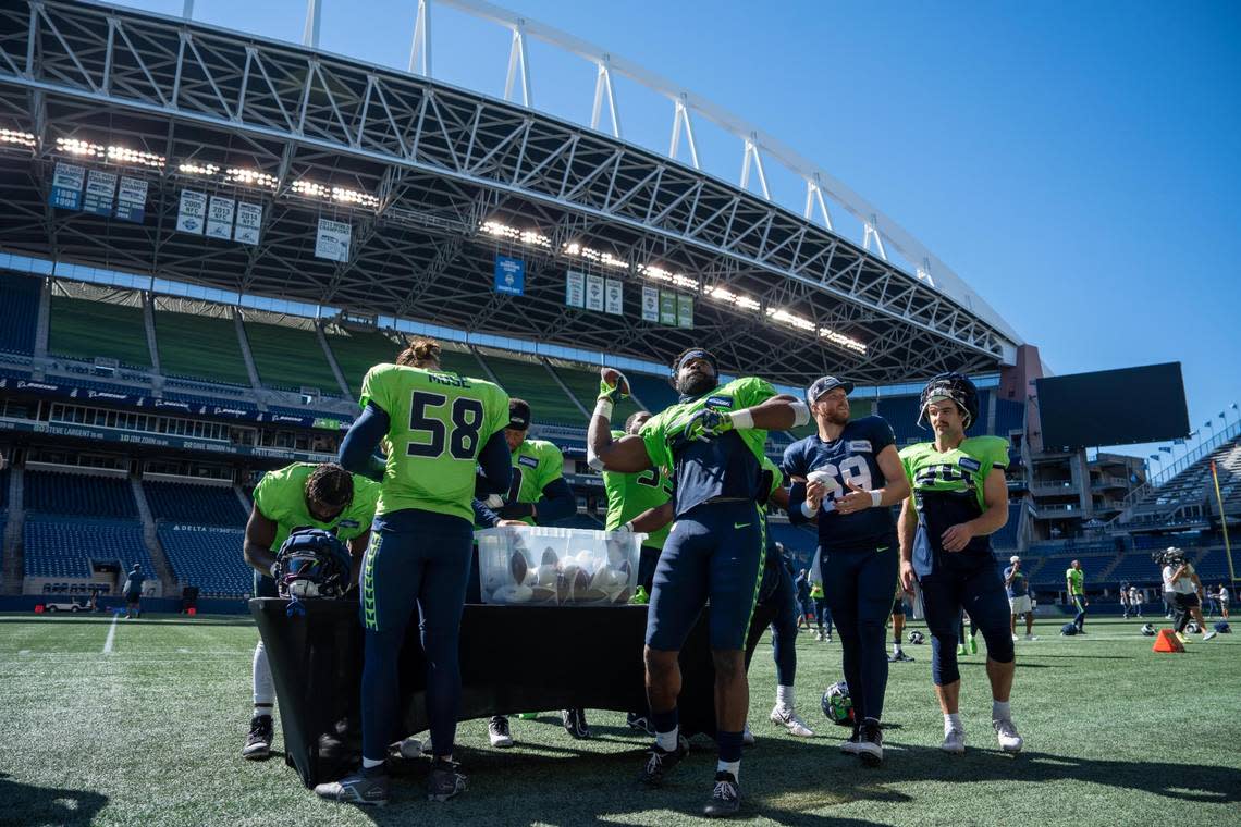 After their mock game, players signed and threw footballs into the crowd for those that came to watch their practice in Lumen Field on Saturday, Aug. 6, 2022 in Seattle, Wash.