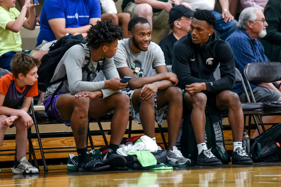 From left, Michigan State guards Jeremy Fears, Tre Holloman and Tyson Walker talk during the Moneyball Pro-Am on Thursday, July 13, 2023, at Holt High School.