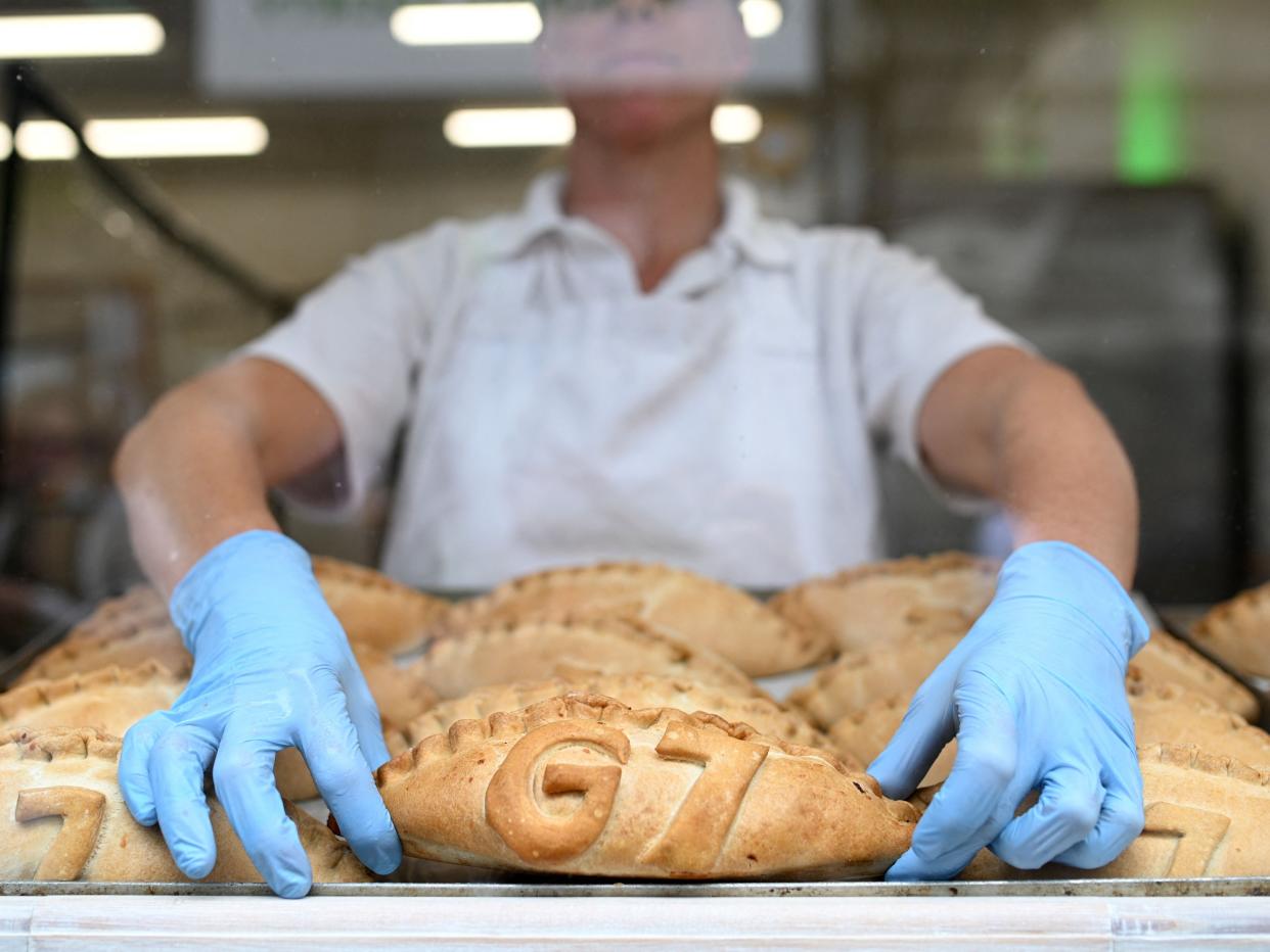 Freshly baked G7 Cornish pasties are placed in the window of a pastry shop in St Ives, Cornwall  (AFP via Getty Images)