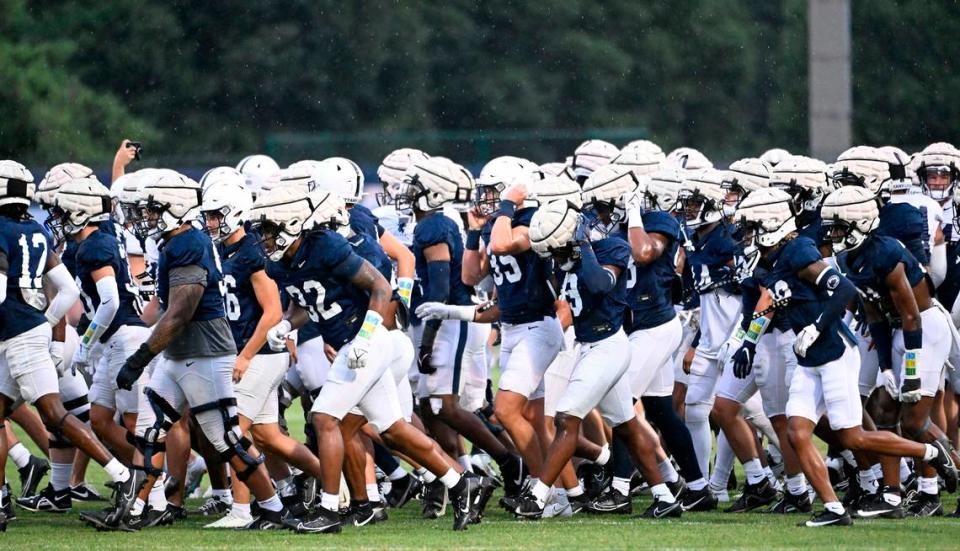 The Penn State football team moves to its practice areas at the Lasch practice field Saturday, Aug. 12, 2023, for a rare fall camp practice open to the public.