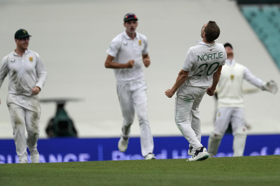 South Africa's Anrich Nortje, right, celebrates taking the wicket of Australia's Marnus Labuschagne during the first day of their cricket test match at the Sydney Cricket Ground in Sydney, Wednesday, Jan. 4, 2023. (AP Photo/Rick Rycroft)