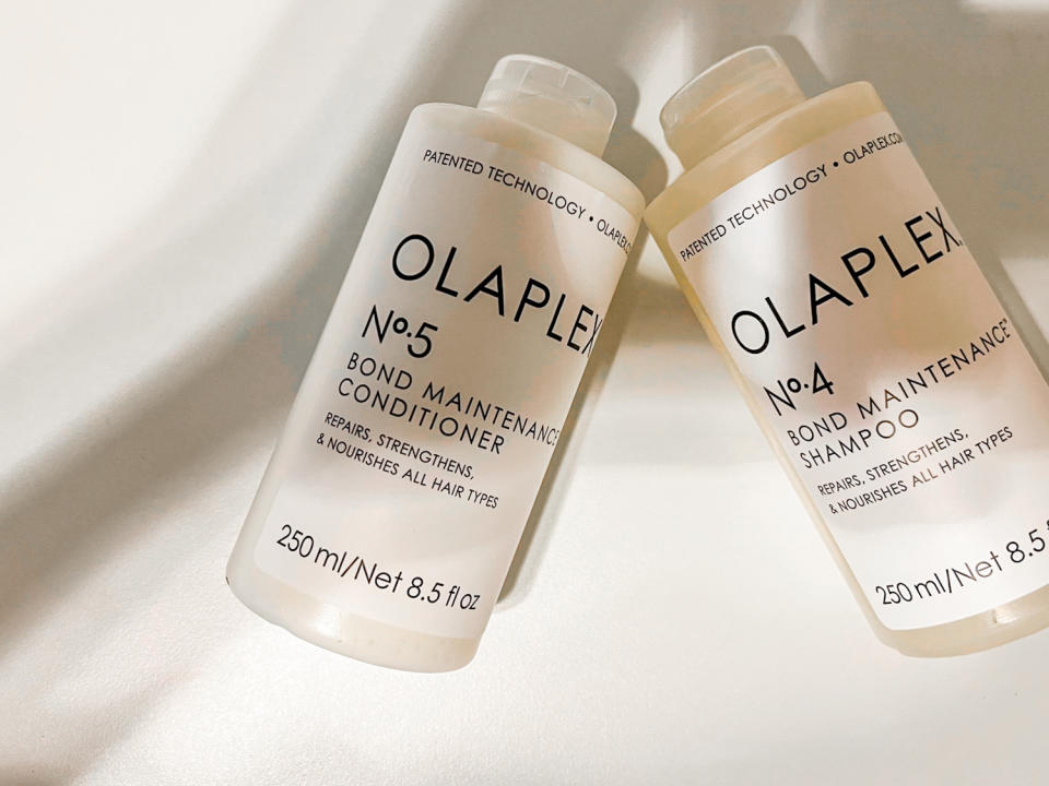 my new olaplex shampoo and conditioner laying on the bed