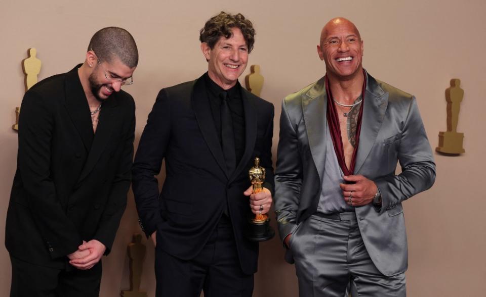 Glazer beams alongside Dwayne “The Rock”: Johnson and Bad Bunny after winning the Oscar for Best International Feature Film. REUTERS