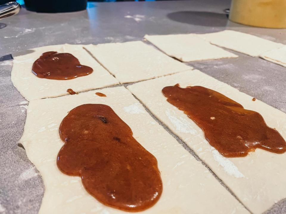 squares of puff pastry with spoonfuls of brown-sugar mixture on top