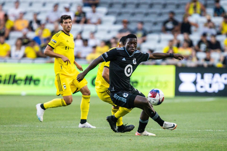 Aug 4, 2023; Columbus, OH, USA; Minnesota United forward Bongokuhle Hlongwane (21) dribbles the ball while Columbus Crew forward Cucho Hernandez (9) defends in the first half at Lower.com Field. Mandatory Credit: Trevor Ruszkowski-USA TODAY Sports