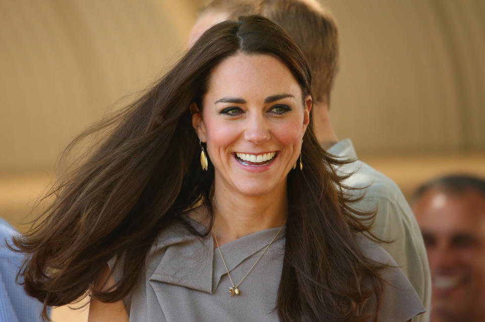 AYERS ROCK, AUSTRALIA - APRIL 22:  Catherine, Duchess of Cambridge smiles as she arives at the National Indigenous Training Academy on April 22, 2014 in Ayers Rock, Australia. The Duke and Duchess of Cambridge are on a three-week tour of Australia and New Zealand, the first official trip overseas with their son, Prince George of Cambridge.  (Photo by Scott Barbour/Getty Images)