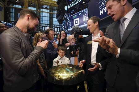 Jack Dorsey (L), CEO of Square and CEO of Twitter, Jim McKelvey co-founder of Square (2nd R) and NYSE President Tom Farley (R) watch as Mac Riley rings a ceremonial opening bell on the floor of the New York Stock Exchange for the IPO of Square Inc., in New York November 19, 2015. REUTERS/Lucas Jackson