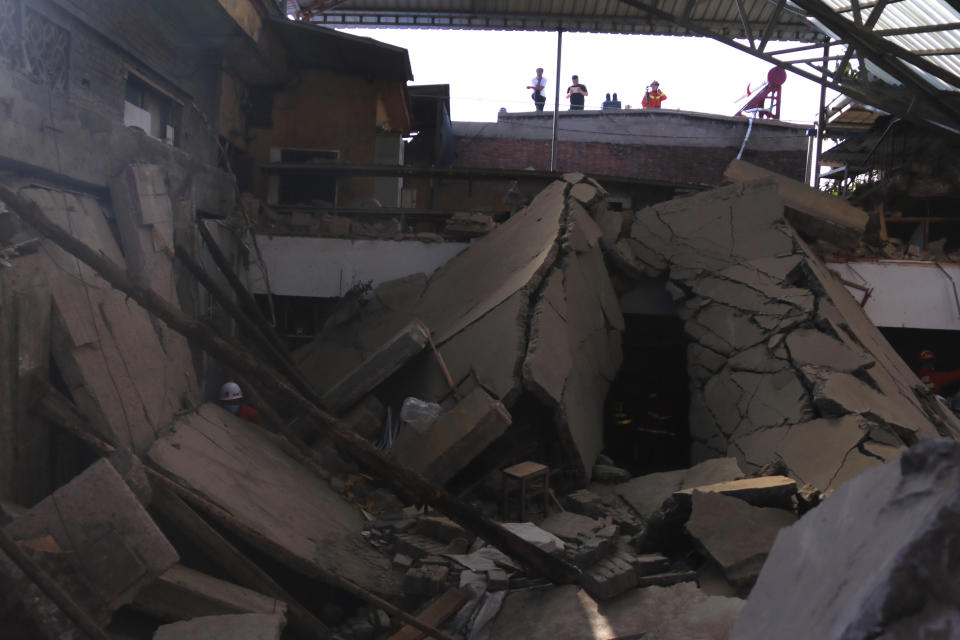 Rescuers search for victims in the aftermath of the collapse of a two-story restaurant in Xiangfen county in northern China's Shanxi province on Saturday, Aug. 29, 2020. More than a dozen were killed after the restaurant collapse during a gathering. (Chinatopix Via AP)