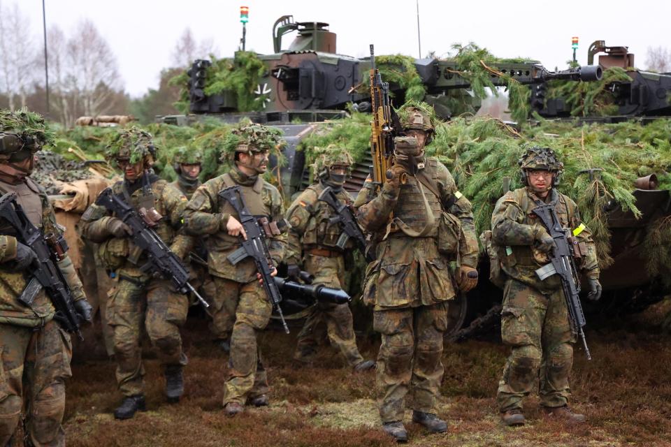 Soldiers of German armed forces Bundeswehr stand by Puma infantry fighting vehicles during firing practice, at armoured infantry training area in Altengrabow, Germany, in January 2023.