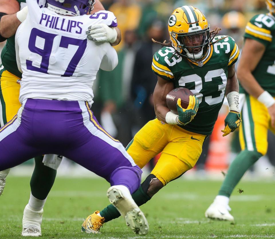 Green Bay Packers running back Aaron Jones runs the ball in their game against the Minnesota Vikings at Lambeau Field.