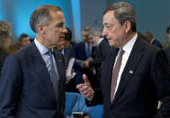 European Central Bank (ECB) President Mario Draghi, right speaks with Bank of England Governor Mark Carney as they attends the International Monetary and Financial Committee (IMFC) conference, at the World Bank/IMF Spring Meetings in Washington, Saturday, April 13, 2019. (AP Photo/Jose Luis Magana)