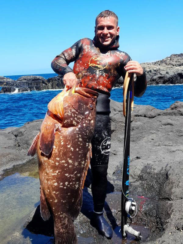 This is the moment a fisherman was delighted when he tried to catch a tiny fish for tea - but ended up netting a massive FOUR STONE grouper