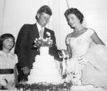 <p>Senator John F. Kennedy and his bride, the former Jacqueline Lee Bouvier, cut their wedding cake the day after their marriage at St. Mary's Church in Newport, Rhode Island. </p>