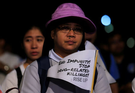 A Catholic nun displays a placard as she participates in a procession against plans to reimpose death penalty and intensify drug war during "Walk for Life" in Luneta park, Metro Manila, Philippines February 24, 2018. REUTERS/Romeo Ranoco