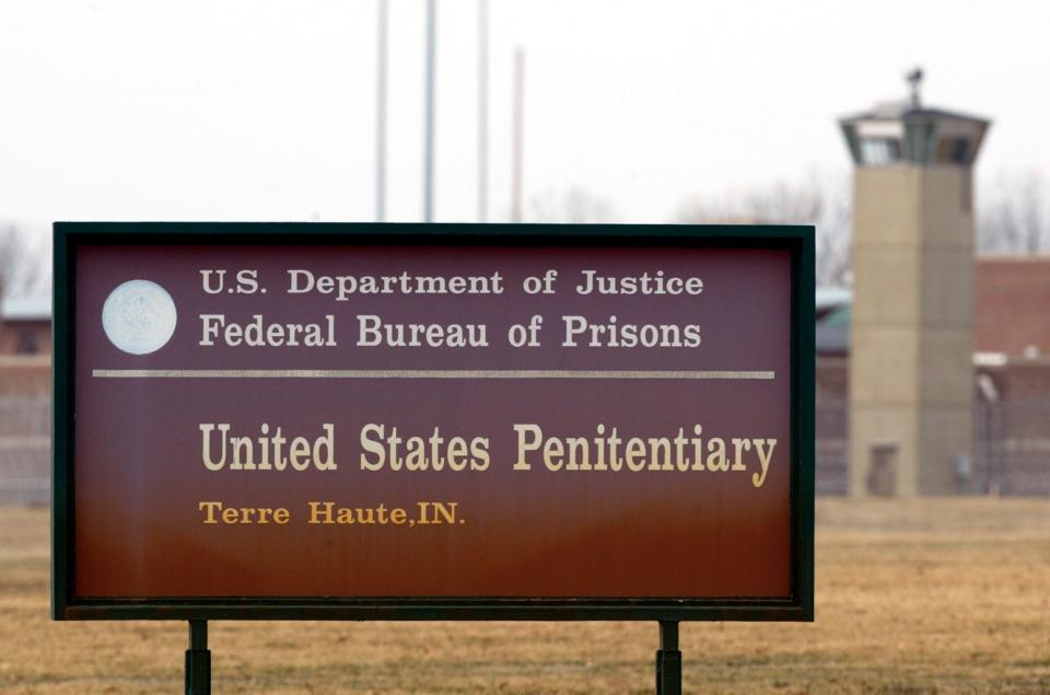 The guard tower flanks the sign at the entrance to the U.S. Penitentiary in Terre Haute, Indiana, site of the last federal execution. This is a March 17, 2003, file photo. The Justice Department says it will carry out executions of federal death row inmates in 2019 for the first time since 2003.