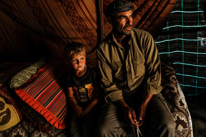 WADI TIRAN, OCCUPIED WEST BANK -- NOVEMBER 30, 2023: Bassam Al ZaOarir, 55, poses for a portrait with his 4-year-old son Amer, in their village Wadi Tiran which is constantly harassed and intimidated with violence by nearby Jewish settlers, in the South Hebron Hills of the Occupied West Bank, Thursday, Nov. 30, 2023. As IsraelOs war against Hamas in Gaza unfolds amid the bombed buildings and deaths of more than 11,000 Palestinians, the increasing violence in the West Bank, which has been occupied by Israel since its 1967 war with Arab nations, is threatening to open another front in the conflict. Armed settlers man checkpoints and at times descend on Palestinian lands destroying hundreds of olive trees and blocking villages in deadly provocations that have led to retaliatory knifings and ambush shootings by Palestinians. (MARCUS YAM / LOS ANGELES TIMES)