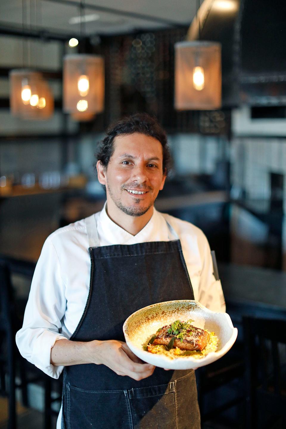 Chef Thomy Nieto with his grilled salmon, butternut squash, charred corn and heirloom tomatoes at B3 Restaurant & Bar at the Kingston Collection on Tuesday, June 14, 2022.