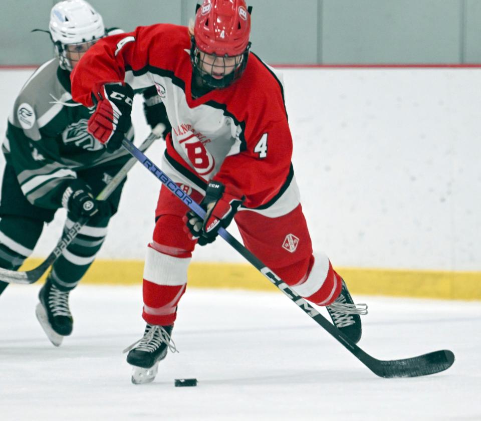 Claire Hazard of Barnstable moves ahead of Leah Woodward of Dennis-Yarmouth.