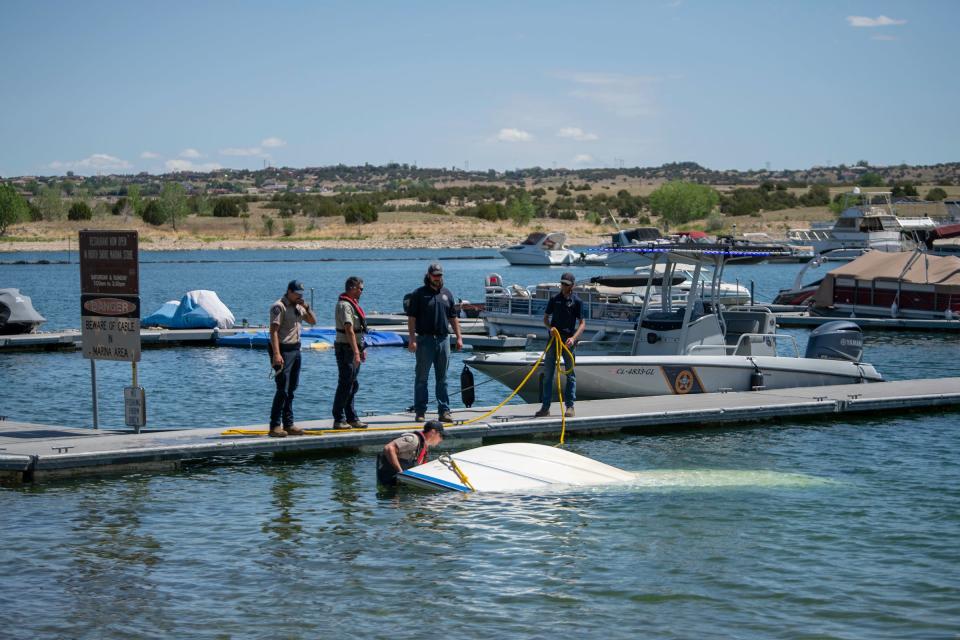 Colorado Parks and Wildlife officers retrieve the boat that capsized on May 29 at Lake Pueblo. Fort Carson officials confirmed three days later that Army Staff Sgt. Joshua Prindle and his wife, Jessica, died in the accident.