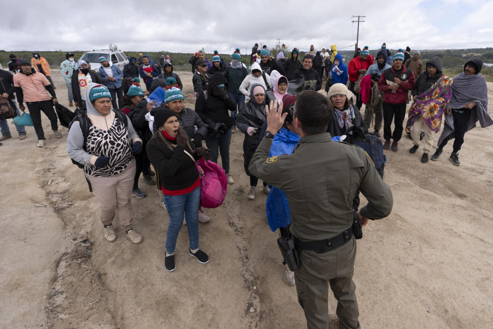 Migrants listen to a Border Patrol agent after crossing the border with Mexico, Thursday, April 25, 2024, in Boulevard, Calif. San Diego became the busiest corridor for illegal crossings in April, according to U.S. figures, the fifth region to hold that title in two years in a sign of how quickly migration routes are changing. (AP Photo/Gregory Bull)