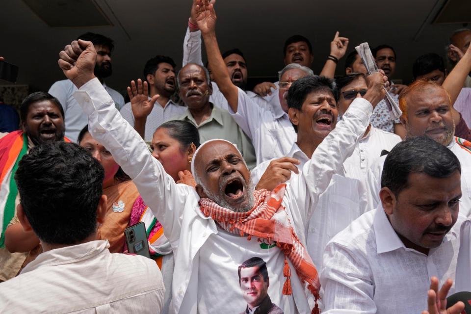 A supporter of opposition Congress party celebrates (AP)