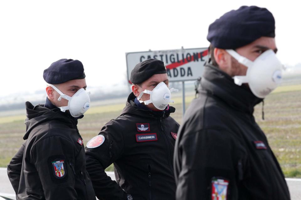 Carabinieri officers stand guard the town of Castiglione D'Adda, which has been closed by the government (REUTERS)