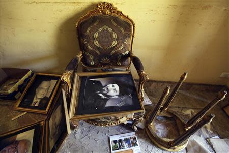 A framed portrait of Muslim Brotherhood founder Hassan Al-Banna lies on a chair in a ransacked room at the Muslim Brotherhood headquarters, in Cairo in this December 8, 2012 file picture. REUTERS/Amr Abdallah Dalsh/Files