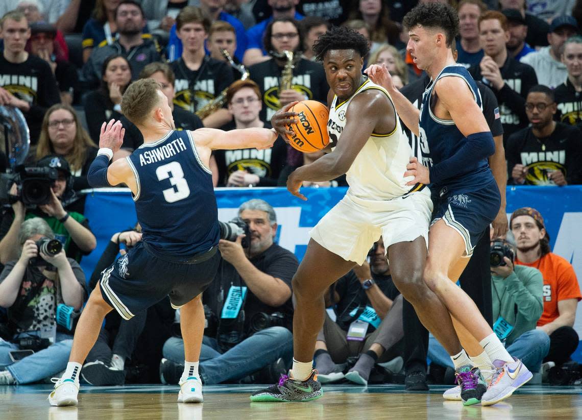 Missouri Tigers guard Kobe Brown (24) is defended by Utah State Aggies guard Steven Ashworth (3) and Utah State Aggies forward Taylor Funk (23) during a game for the NCAA Tournament at Golden 1 Center in Sacramento, Thursday, March 16, 2023.