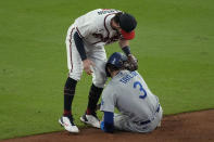 Los Angeles Dodgers' Chris Taylor (3) is tagged out by Atlanta Braves shortstop Dansby Swanson after being caught in a run down on base hit by Dodgers' Cody Bellinger during the ninth inning in Game 1 of baseball's National League Championship Series Saturday, Oct. 16, 2021, in Atlanta. (AP Photo/John Bazemore)