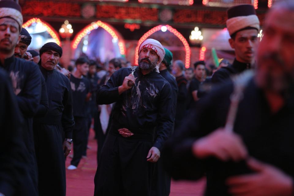 Shiite Muslim worshippers perform their rituals inside the holy shrine of Imam Hussein during the Muharram procession in Karbala, Iraq, Saturday, Aug. 29, 2020. Saturday, Aug. 29, 2020. The holiday marks the end of the forty day mourning period after the anniversary of the martyrdom of Imam Hussein, the Prophet Muhammad's grandson in the 7th century. (AP Photo/Anmar Khalil)