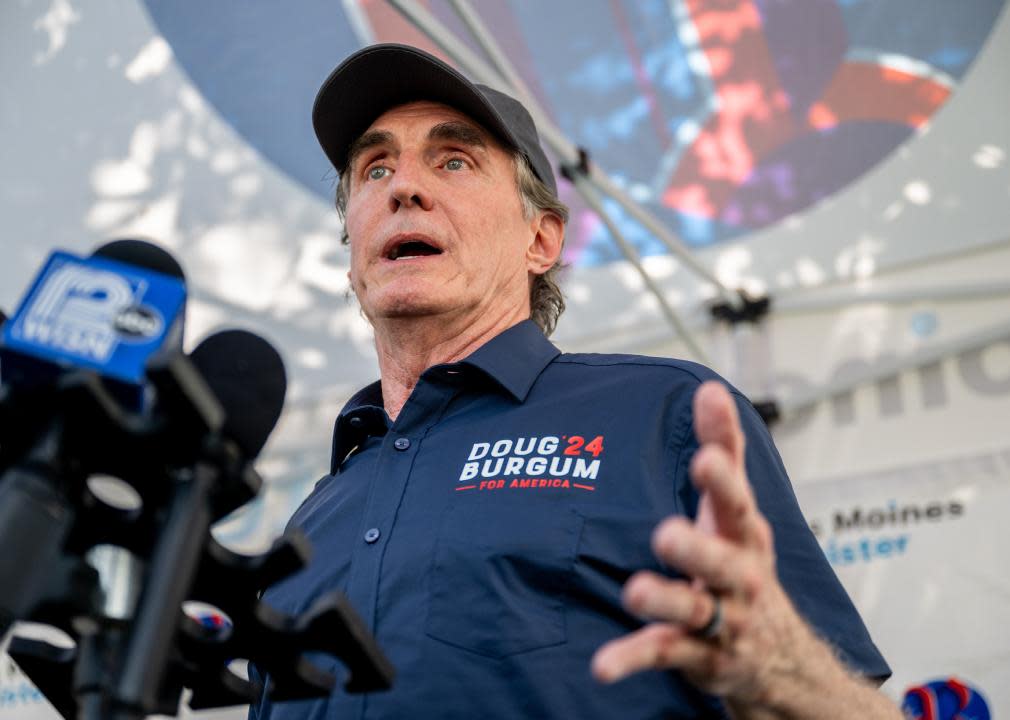 Doug Burgum speaks to the press after speaking during a campaign rally.