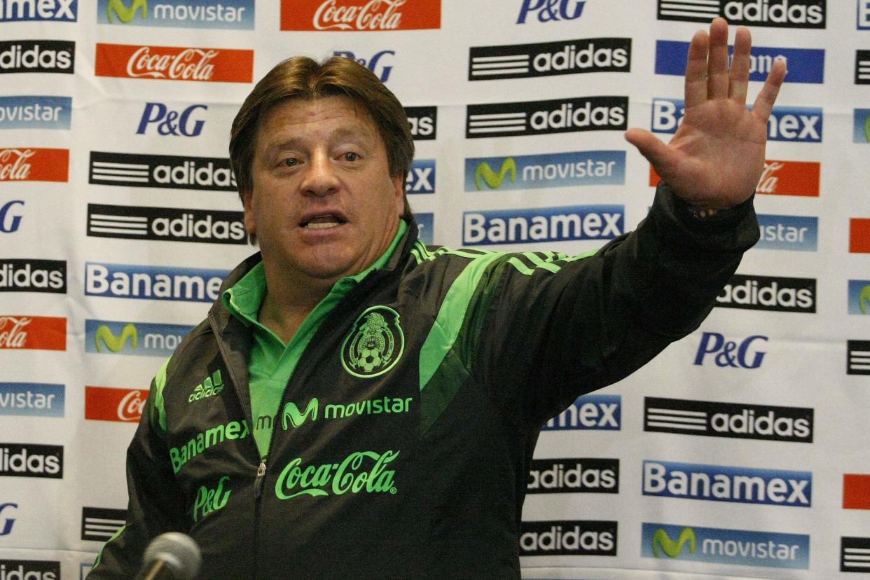 Mexico&#39;s coach Miguel Herrera waves to photographers during a news conference after the team&#39;s arrival to the Benito Juarez international airport in Mexico City June 30, 2014. Mexico&#39;s World Cup roller-coaster came to abrupt end on Sunday when they suffered a heart-breaking loss to the Netherlands in the last 16. The soccer gods, who had smiled on Mexico during their troubled qualifying campaign, finally abandoned El Tri when they were just minutes away from reaching the quarter-finals. REUTERS/Bernardo Montoya (MEXICO - Tags: SPORT SOCCER WORLD CUP)