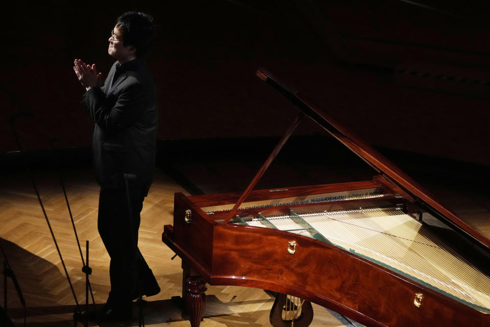 Canadian pianist Eric Guo thanks the audience after performing Frederic Chopin's Concerto in F minor on a replica of a 1830 Pleyel piano during a concert marking the 19th century piano virutoso and composer's 214th birthday, in Warsaw, Poland, on Friday, March 1, 2024. Guo won a quintannual competition to play Chopin on period instruments organized by the Fryderyk Chopin Institute. (AP Photo/Czarek Sokolowski)