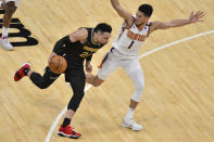 Memphis Grizzlies guard Dillon Brooks (24) drives against Phoenix Suns guard Devin Booker (1) in the second half of an NBA basketball game Monday, Jan. 18, 2021, in Memphis, Tenn. (AP Photo/Brandon Dill)