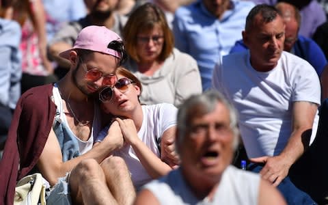 People hug as they observe one minute silence in Manchester - Credit: Leon Neal /Getty