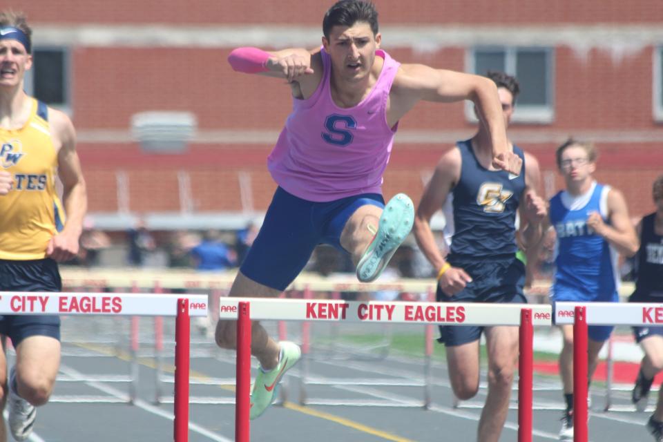 Saugatuck's Benny Diaz leaps over a hurdle en route to a 300 hurdles Division 3 state title Saturday in Kent City. He won the 100-meter dash, the 110-meter hurdles and the 300-meter hurdle races Saturday. But Diaz suffered an injury during the 200-meter race, which opened the door for Lansing Catholic to win the state championship.