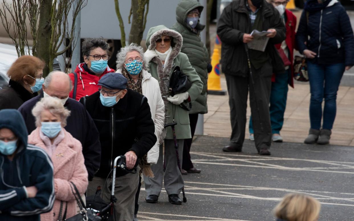 Members of the public queue to receive the Oxford/AstraZeneca Covid-19 vaccine at the NHS vaccine centre that has been set up at Epsom Racecourse  -  Getty Images Europe