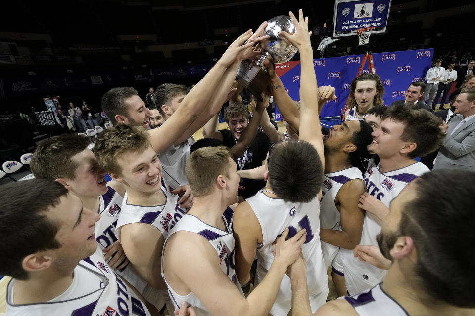 College of Idaho players celebrate after their NAIA men's national championship college basketball game against Indiana Tech Saturday, March 18, 2023, in Kansas City, Mo. College of Idaho won 73-71. (AP Photo/Charlie Riedel)