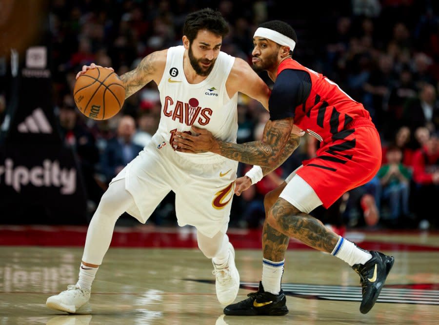 Cleveland Cavaliers guard Ricky Rubio, left, dribbles around Portland Trail Blazers guard Gary Payton II during the first half of an NBA basketball game in Portland, Ore., Thursday, Jan. 12, 2023. (AP Photo/Craig Mitchelldyer)