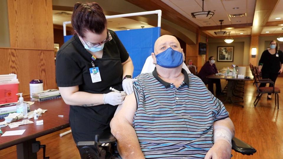 Jummy Schultz is given a dose of the Moderna COVID-19 vaccination Wednesday, Dec. 30, 2020 at the St. Benedict's Community in St. Cloud.