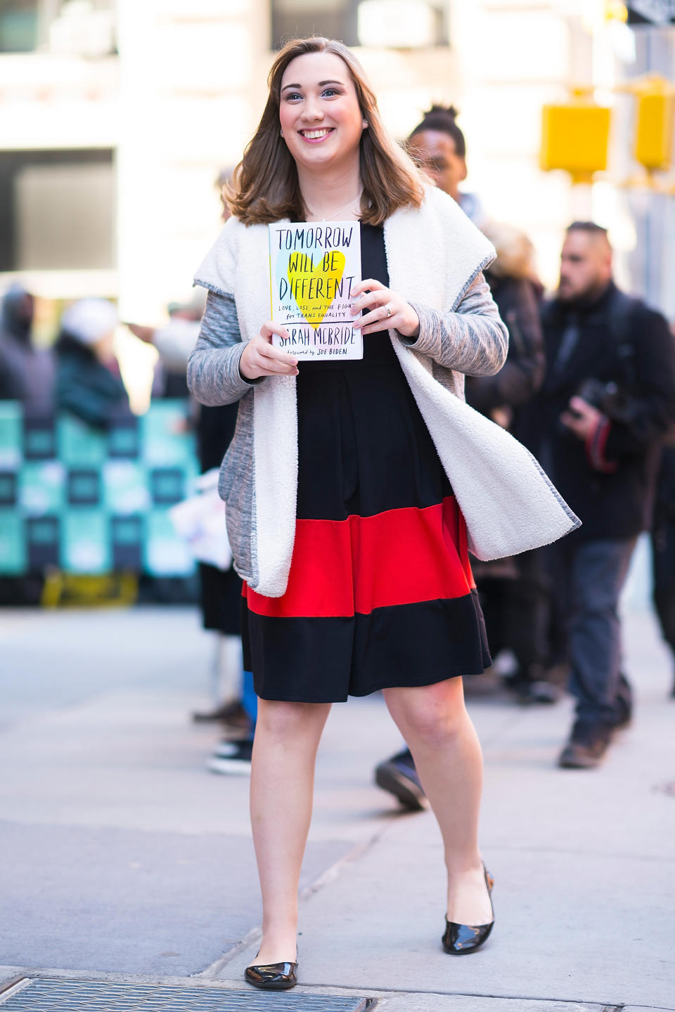 McBride holding her memoir <i>Tomorrow Will Be Different</i>. (Photo: Gotham via Getty Images)