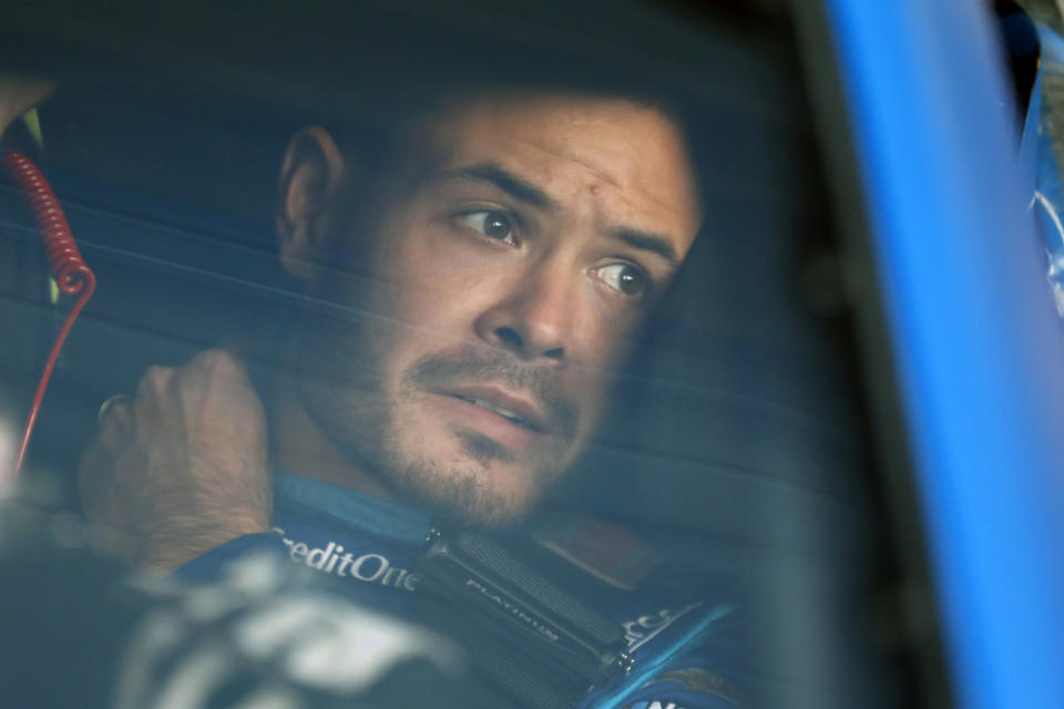 FILE - In this Oct. 18, 2019, file photo, Kyle Larson sits in his car before the final practice for a NASCAR Cup Series auto race at Kansas Speedway in Kansas City, Kan. Kyle Larson was fired by Chip Ganassi Racing, a day after nearly every one of his sponsors dropped the star driver for using a racial slur during a live stream of a virtual race. Of course, in a sport with an extremely checkered racial history, he's already lined up a new gig for 2021 at Hendrick Motorsports. (AP Photo/Colin E. Braley, File)