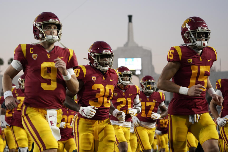 Southern California players run off the field after warming up before an NCAA college football game against Oregon for the Pac-12 Conference championship Friday, Dec 18, 2020, in Los Angeles. (AP Photo/Ashley Landis)