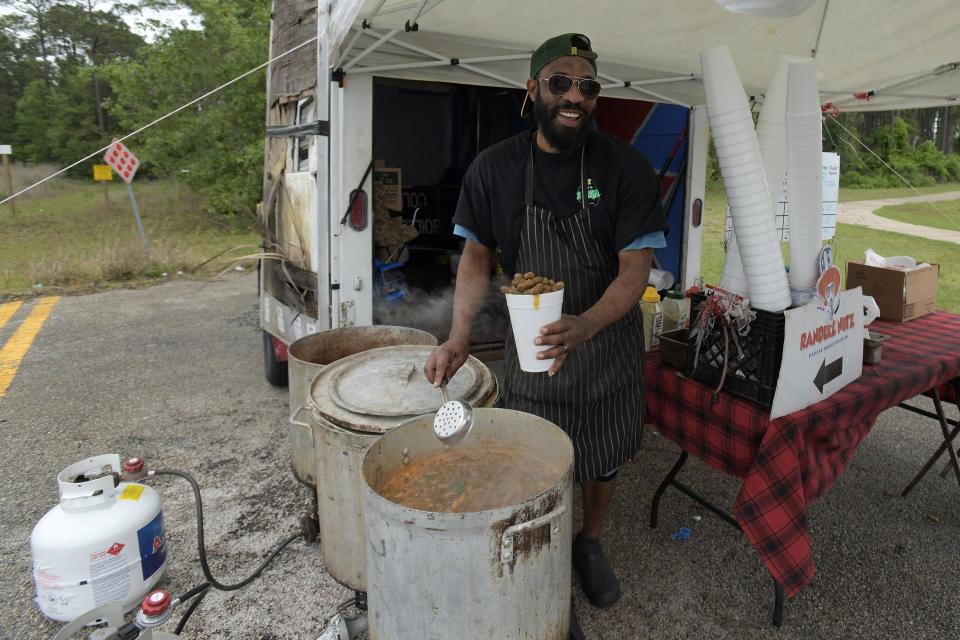 Randy Waters serves up his specialty boiled peanuts from his roadside trailer at the eastern end of Racetrack Road Saturday, April 17, 2021.
