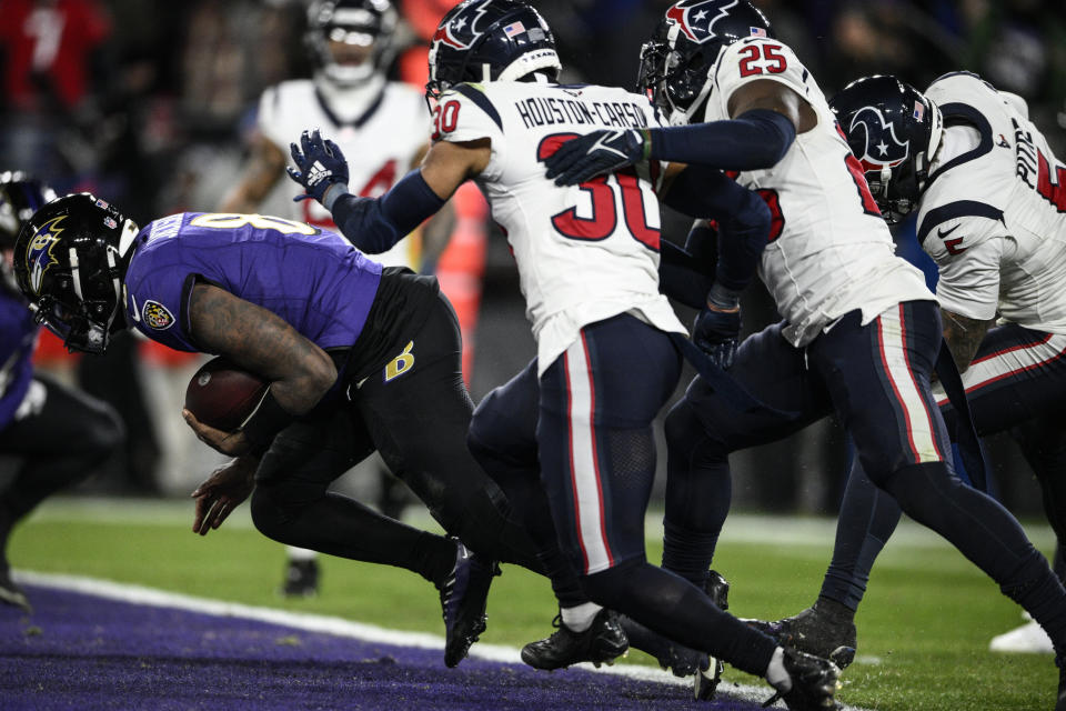 Baltimore Ravens quarterback Lamar Jackson (8) runs into the end zone for a touchdown against the Houston Texans during the second half of an NFL football AFC divisional playoff game, Saturday, Jan. 20, 2024, in Baltimore. (AP Photo/Nick Wass)