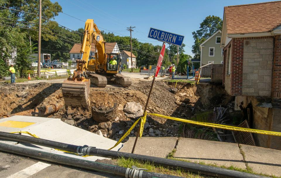 Work continues on the collapsed intersection of Pleasant and Colburn streets Thursday.