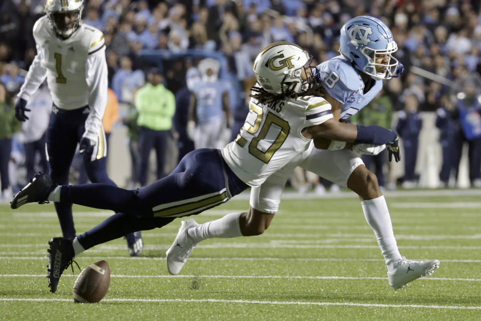 Georgia Tech defensive back LaMiles Brooks (20) breaks up a pass intended for North Carolina wide receiver Kobe Paysour (8) during the first half of an NCAA college football game, Saturday, Nov. 19, 2022, in Chapel Hill, N.C. (AP Photo/Chris Seward)