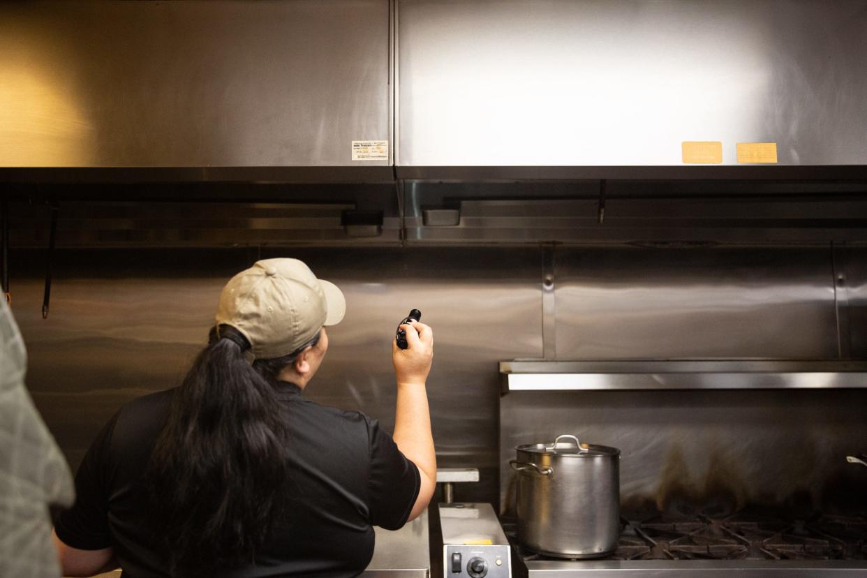 Joanie Garza, a public health inspector with the city, checks the hood vents in a kitchen during a restaurant inspection June 6, 2023, in Corpus Christi, Texas.